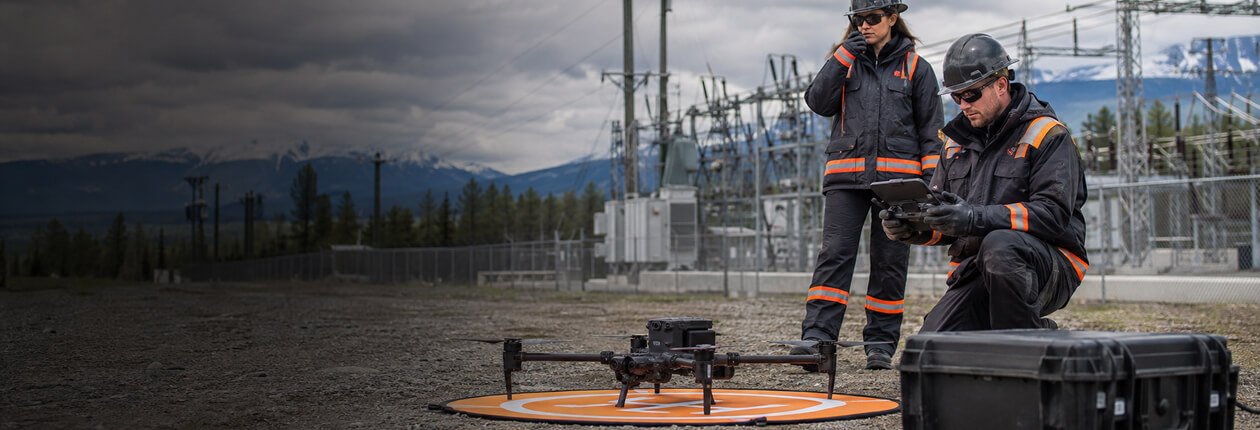 Drone flying above a forested lakeshore